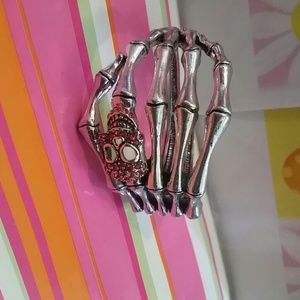 silver tone pink gem skull hand bracelet